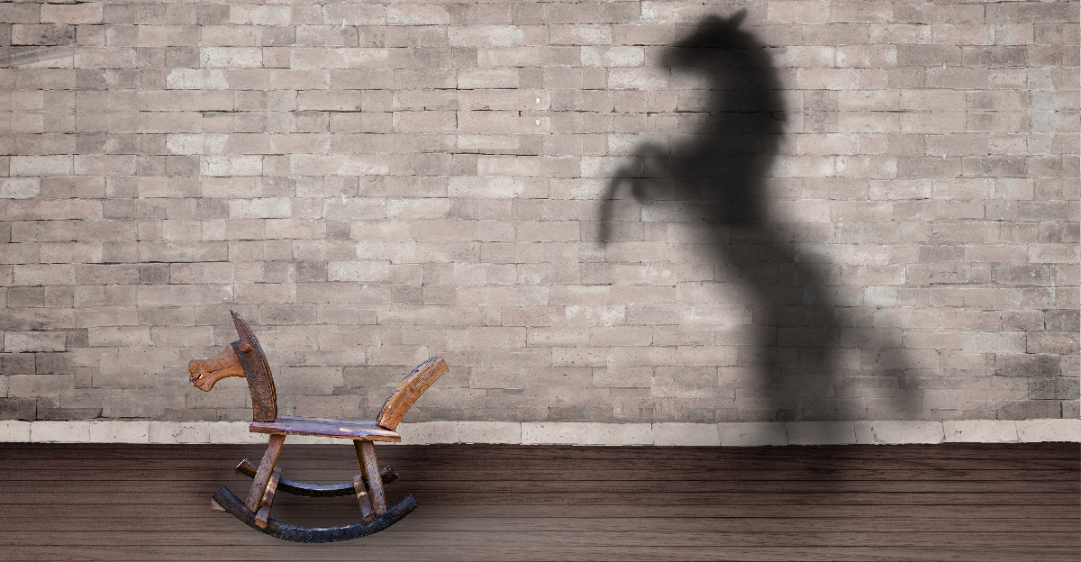 Concept of hidden potential. Rocking horse in front of a large shadow of a horse.