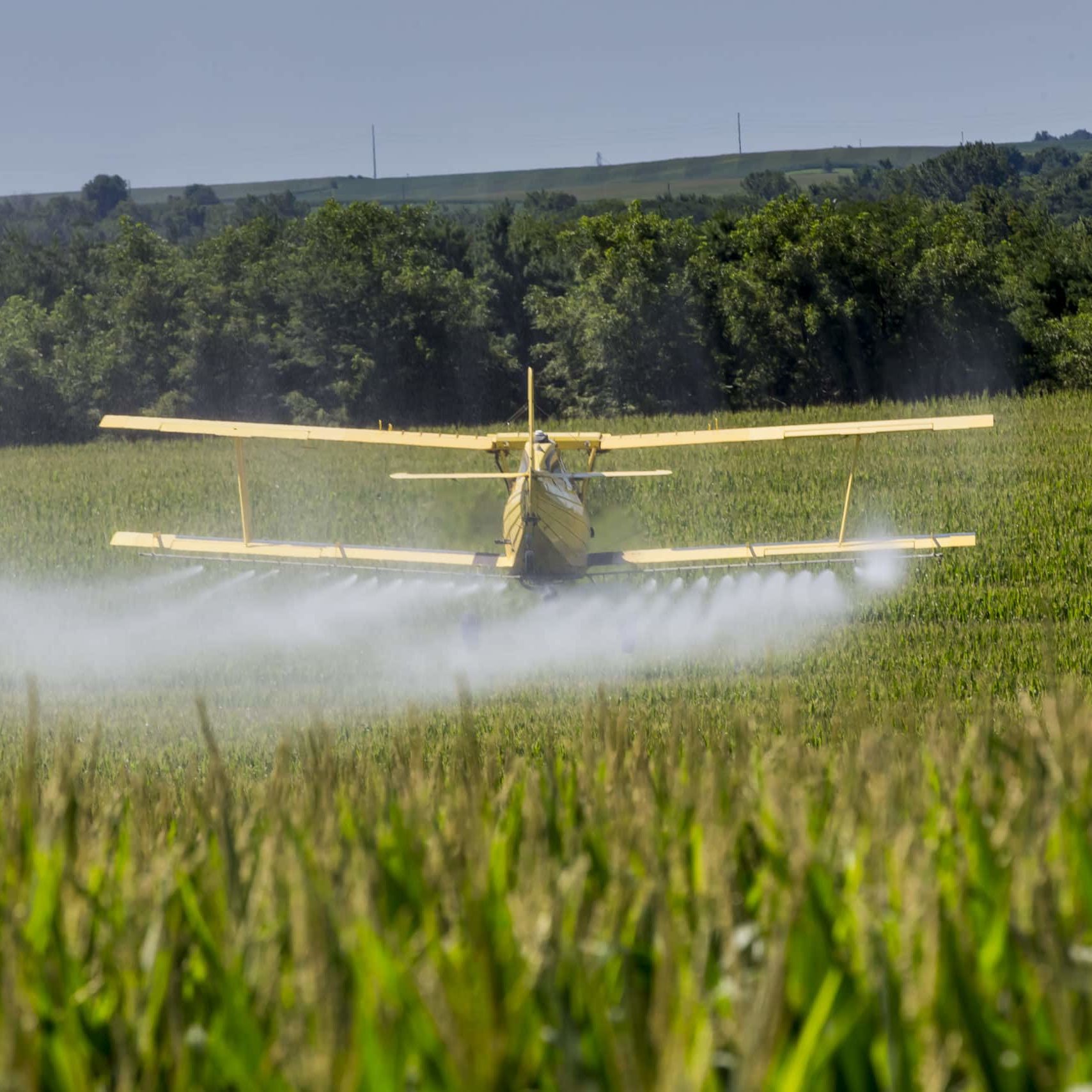 Plane flying over crops