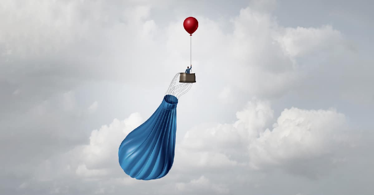 Businessman in Hot Air Balloon Recovering from a Disaster