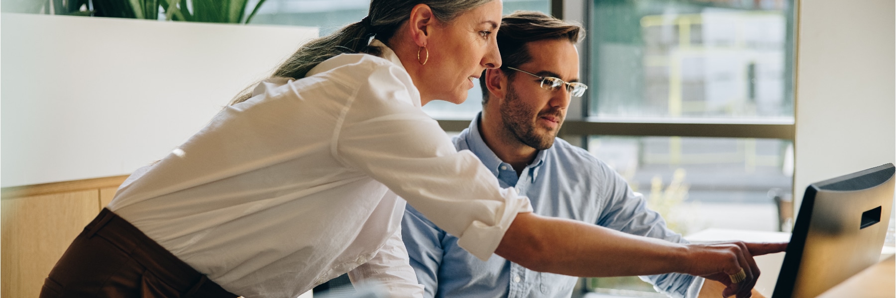 Man and Woman Collaborating with Enterprise Resource Planning Software