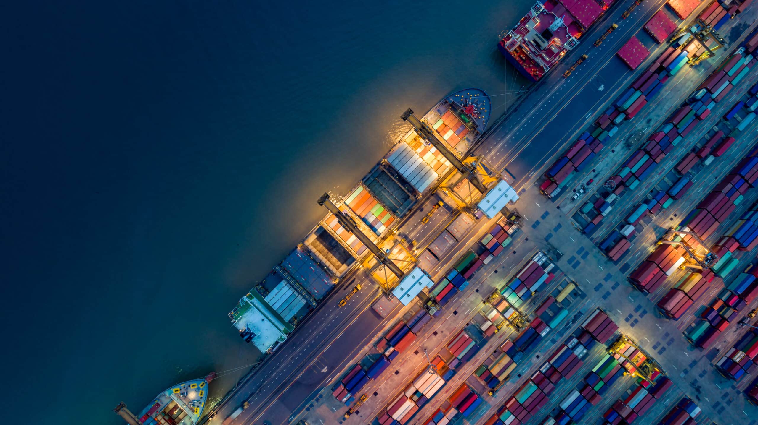 Logistics and transportation of Container Cargo ship and Cargo plane with working crane bridge in shipyard at sunrise, logistic import export and transport industry background