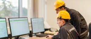 Field service engineers inspect relay protection system with laptop computer