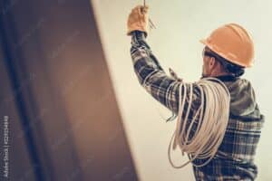 field worker with chords and wires