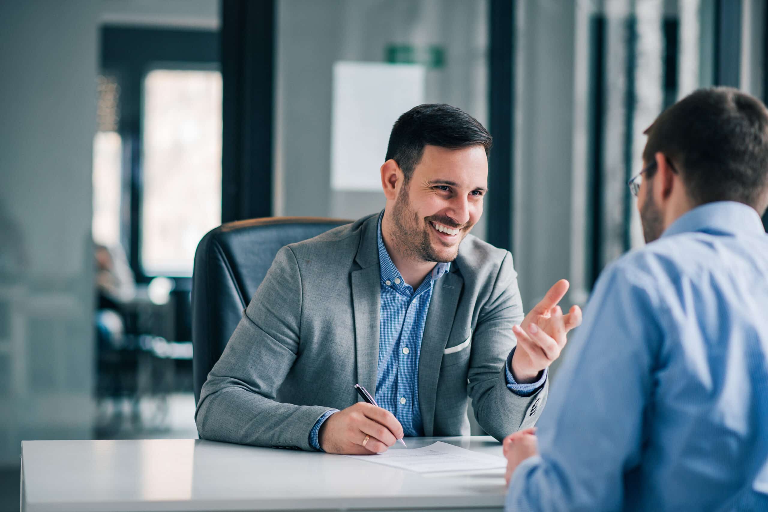 man laughing during meeting