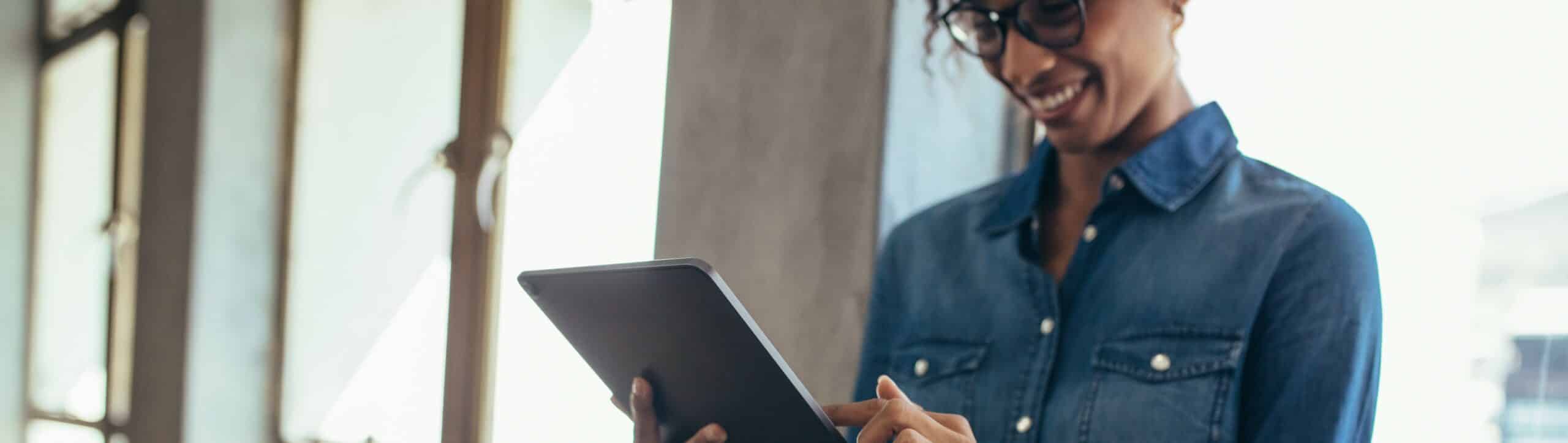 Female entrepreneur in office using digital tablet
