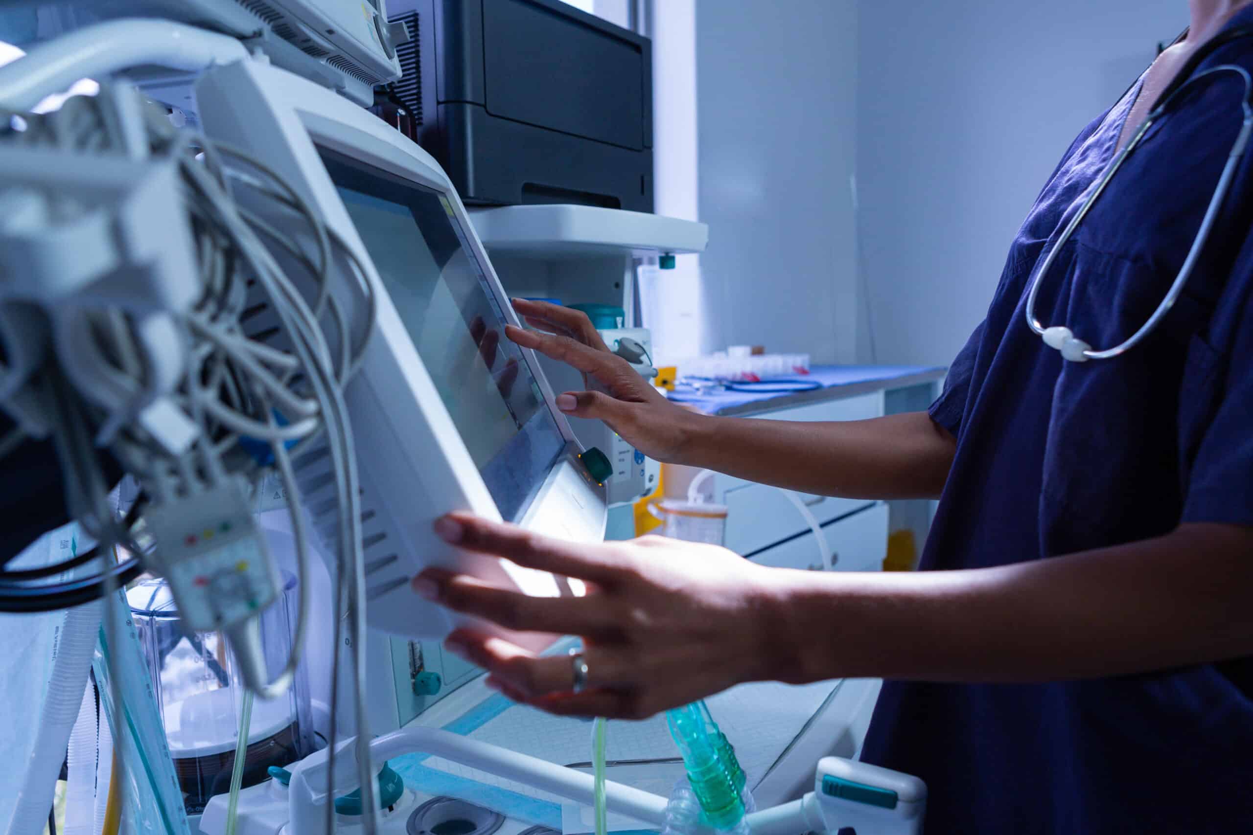 surgeon in scrubs with medical device