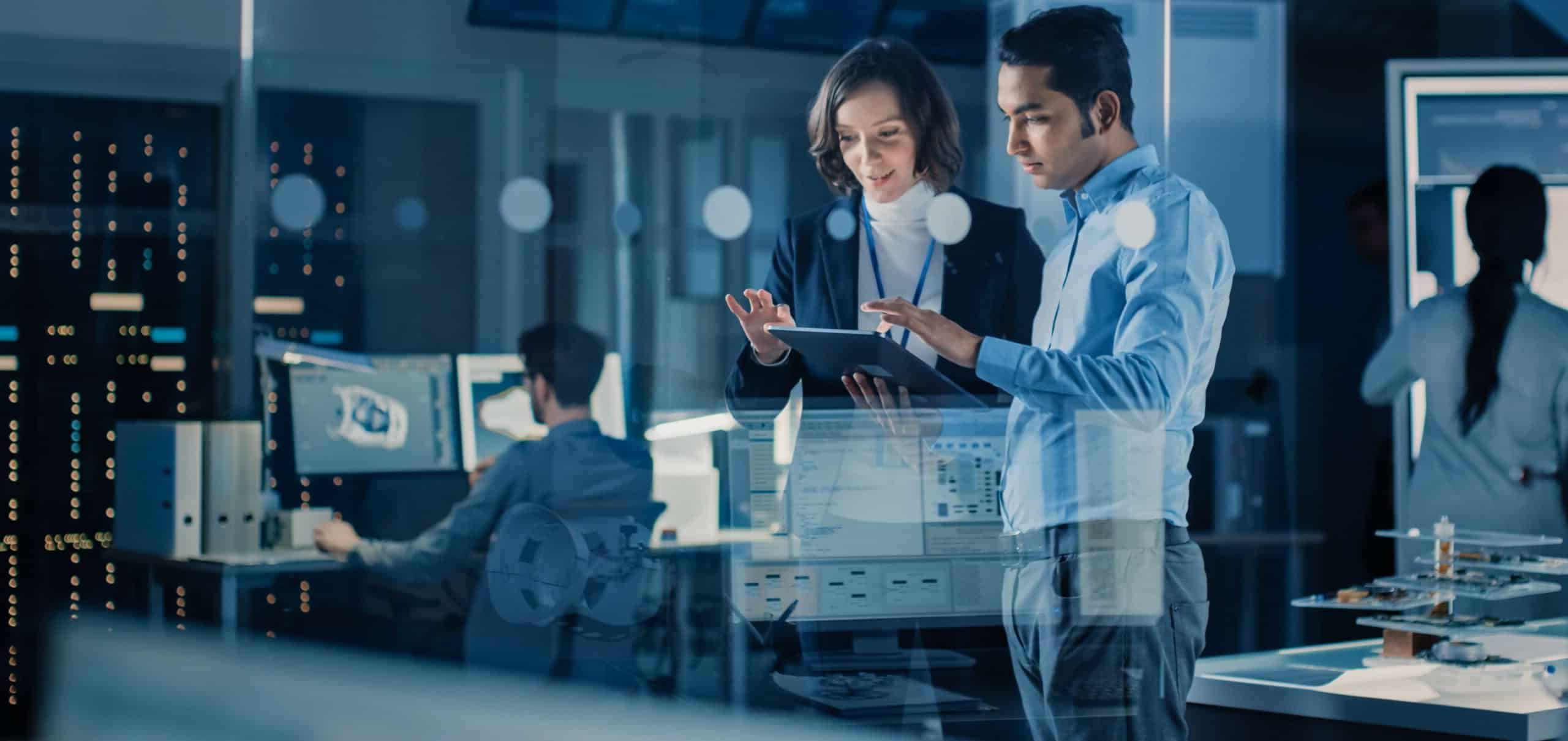 two people in a lab looking at tablet