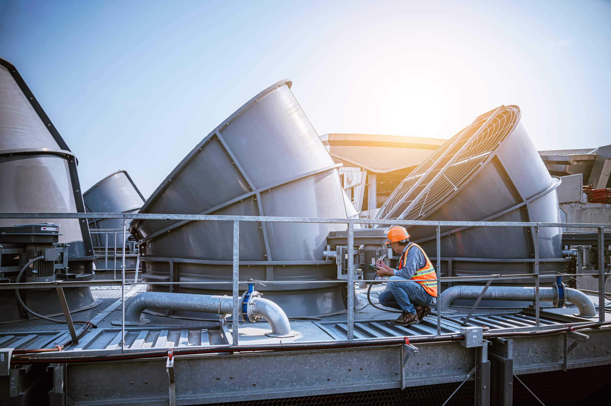 A engineer under checking the industry cooling tower air conditioner