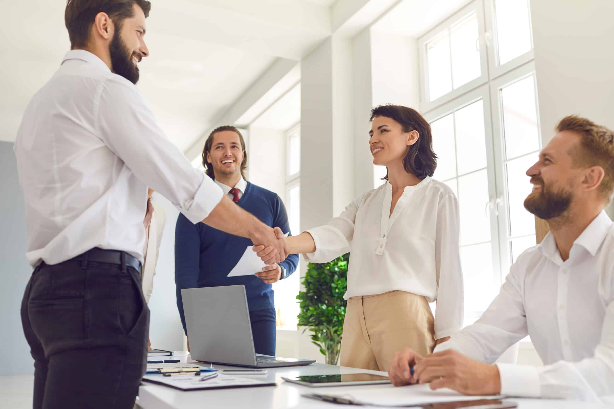 woman and man shaking hands after meeting