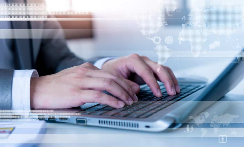 Close up of business man typing on laptop erp for project-based company