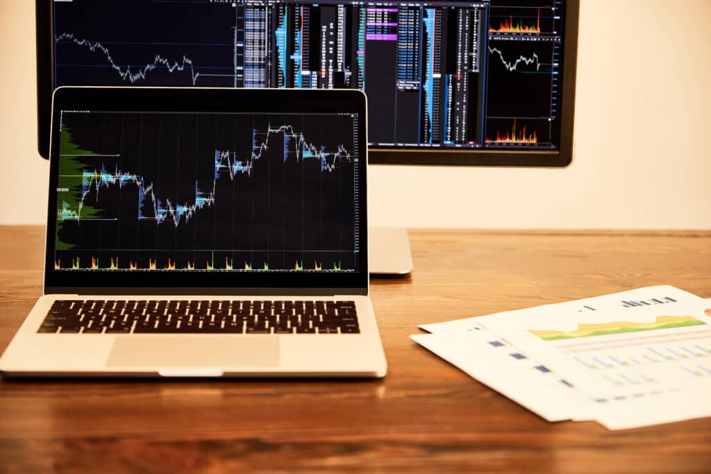Laptop and computer with charts and graphs- reporting for professional services