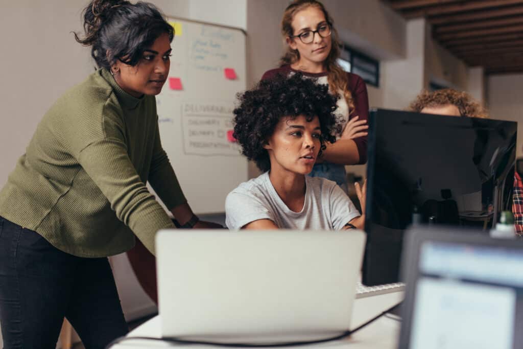 woman gathered around a lap top