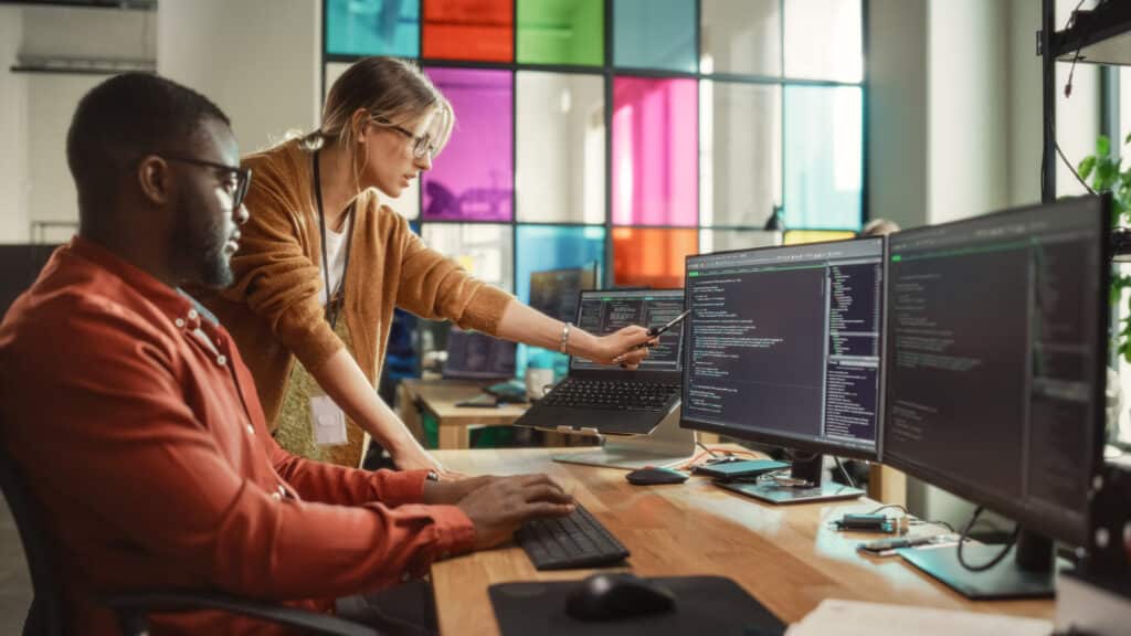 2 workers at a computer