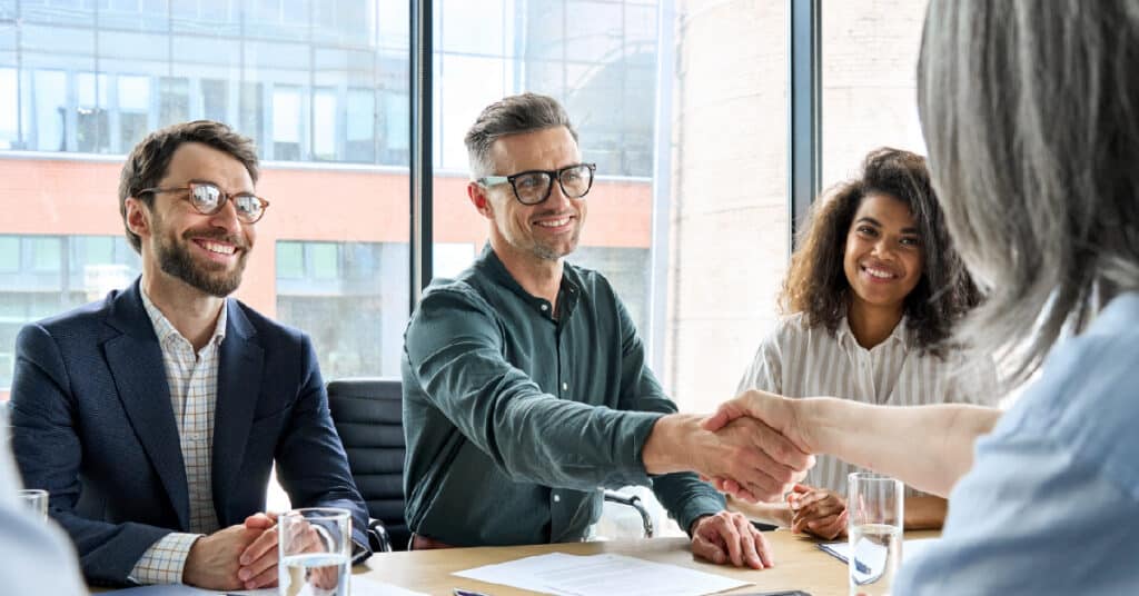 Salespeople shaking hands.