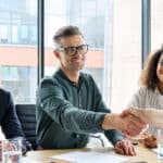 Salespeople shaking hands.