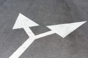 White painted arrows on asphalt road