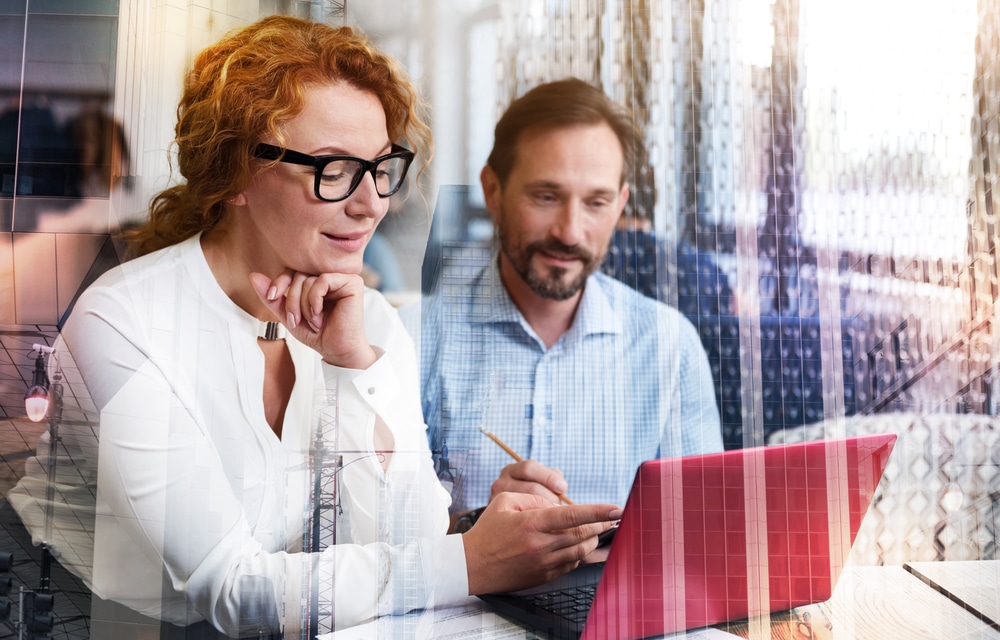 woman making remarks to a man on laptop about digital transformation initiative