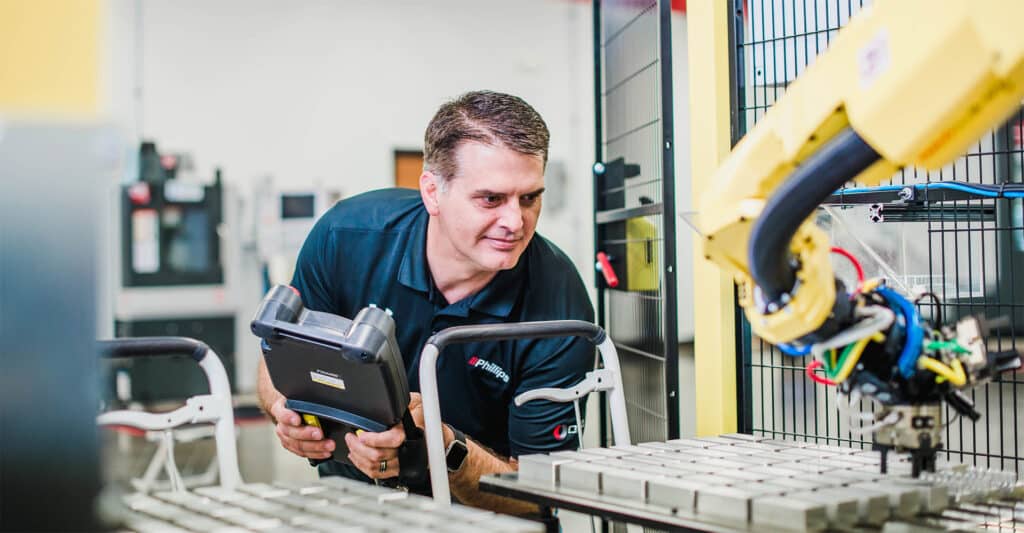 Man looking at machine- Phillips Corporation