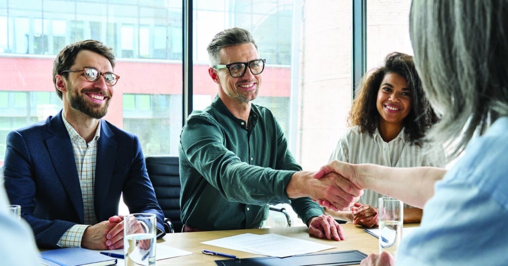 Sales people shaking hands